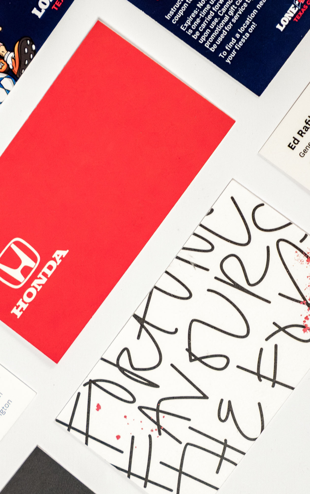 Standard business cards on a light surface.